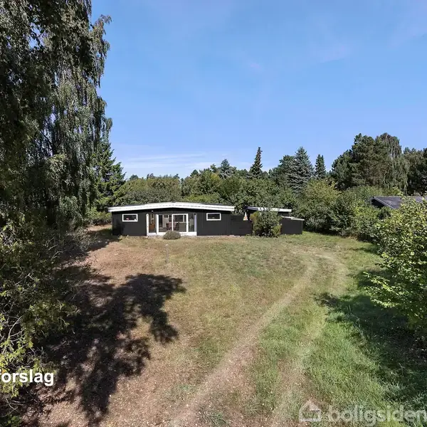 Hus vises som "facadeforslag" omkranset af græs og store træer under en blå himmel.