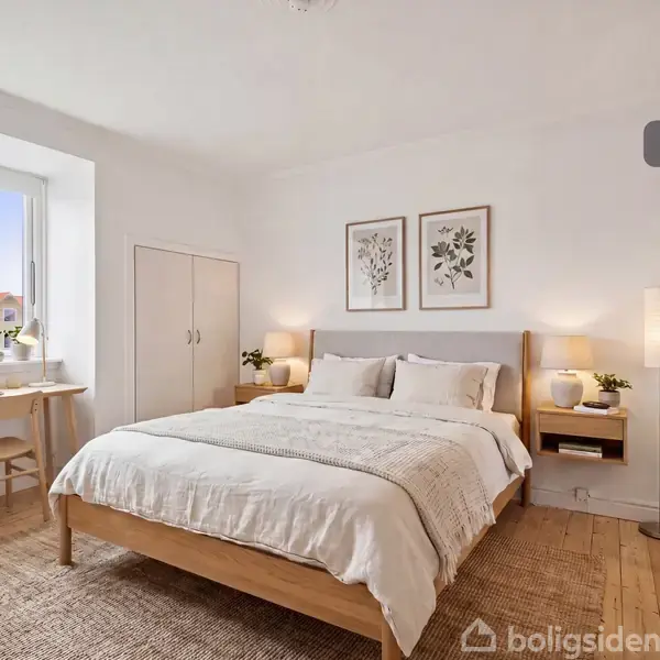 Soveværelse med seng arrangeret i midten, omgivet af natborde med lamper. Der er et skrivebord ved vinduet. Væggene er dekoreret med to botaniske billeder. Tekst: "Visualisering".
