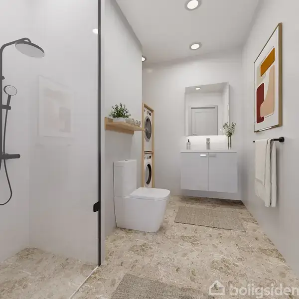 Badeværelse med toilet og brusekabine til venstre, vaskemaskine og tørretumbler stablet i midten. Vask med spejl og hvid skab til højre, håndklæde på væggen.