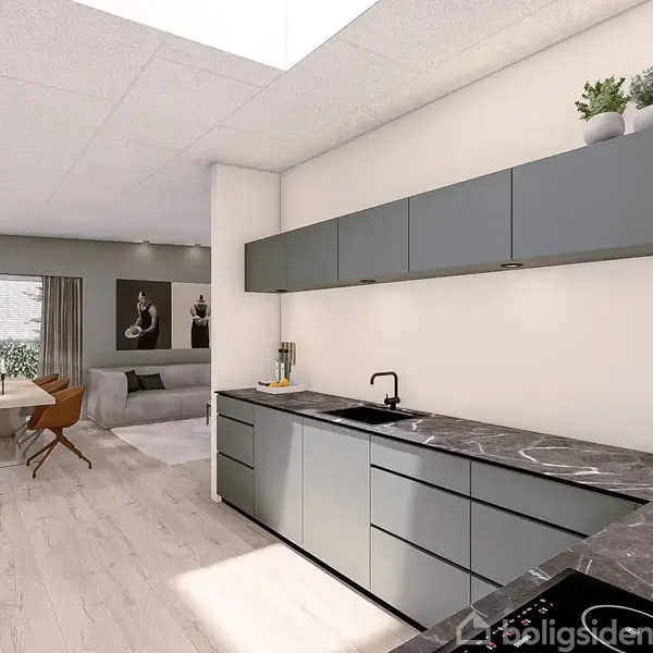 Moderne køkken med mørkegrå skabe og sort vask i marmorbordplade. Aktion: Lysindfald fra ovenlysvindue. Kontekst: I baggrunden ses en spisestue med råhvide vægge og billeder.
