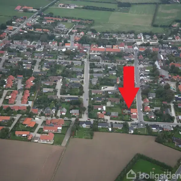 Rødt pil peger mod et hus i en tætbygget boligområde med mange huse, veje og marker i periferien.