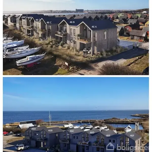 Lejlighedsbygning ved navn 46A står ved kysten med parkerede både ved siden af. Udsigten inkluderer en bådehavn og havet i baggrunden under en klar blå himmel.