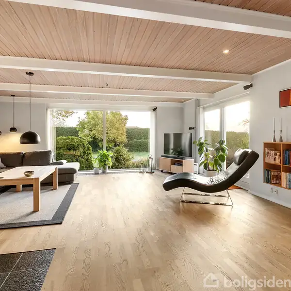 Stue med grå hjørnesofa og sofabord, dekoreret med hængelamper. En chaiselong er placeret ved glasdøre med udsigt til en have. Reoler med bøger hænger på væggen.