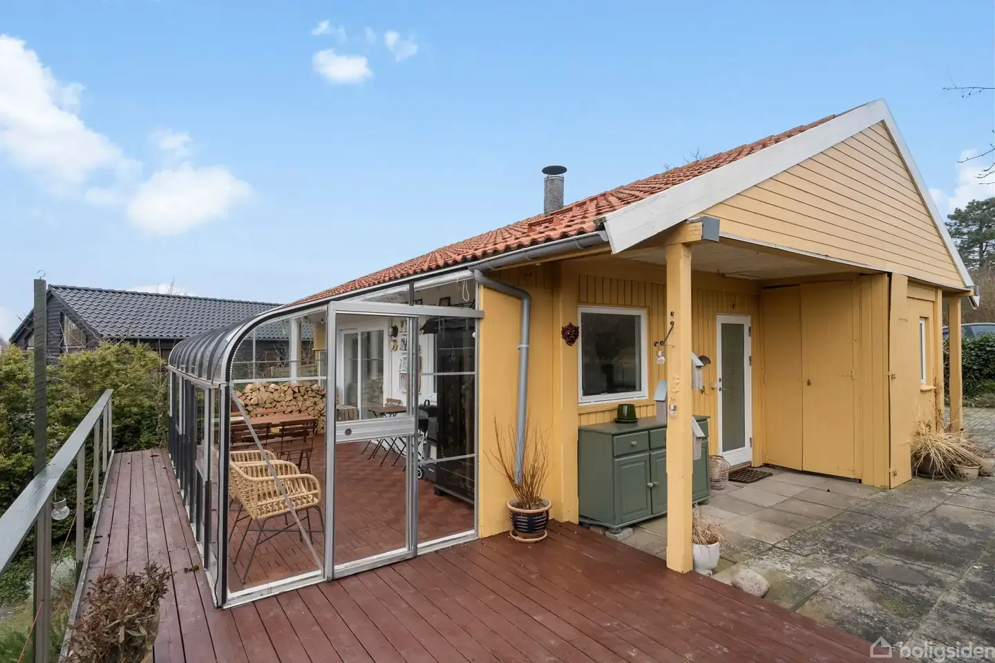 Sommerhus med orangeri og udsigt til haven.