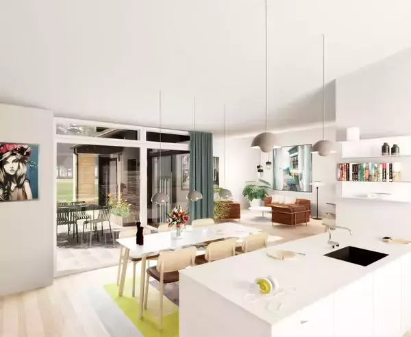 Køkken-alrum med spisebord og stole. Hængende lamper over bordet. Køkkenø med vask og dekoration. Stue med sofaer i baggrunden. Glasdøre åbner til terrasse med bord og stole.