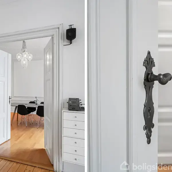Et hvidt rum med trædør åbner til en stue med sort møblering. Nærbillede af dørhåndtag med ornamentik. Trægulve og lyskrone ses i baggrunden.