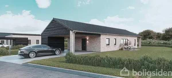 En moderne villa med murstensfacade står ved siden af en parkeret bil på en asfalteret indkørsel. Villaen har en velplejet græsplæne og er omgivet af natur.